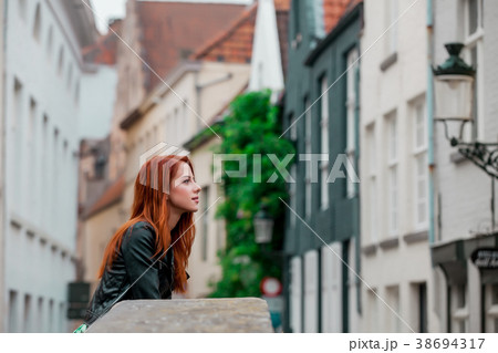 Young redhead girl rest on the street in Brugge 38694317
