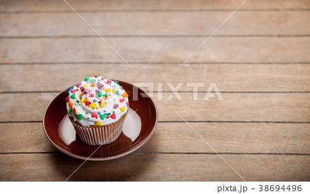 Colorful cupcake on a plate Colorful cupcake on a plate 38694496