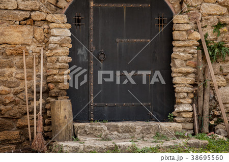 doors with broom and woods in brick wall fortress 38695560