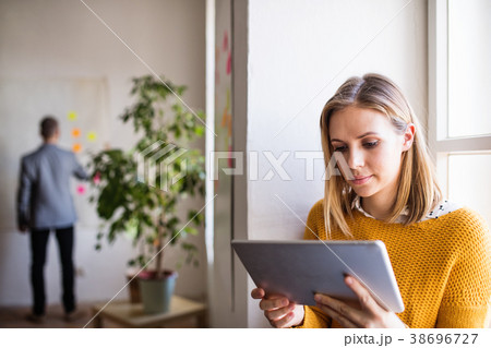 Two business people with tablet in the office. Two business people with tablet in the office. 38696727