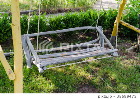 Wooden swing hand-made in the garden. Wooden swing hand-made in the garden. 38699475