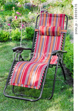 Chaise-longue in the summer sunny garden. Chaise-longue in the summer sunny garden. 38699476