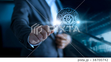Businessman'n magnifying glass of gears to success Businessman'n magnifying glass of gears to success 38700742