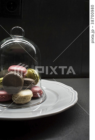 color macaroon cookies on plate, dark background 38700980