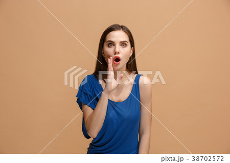 The young woman whispering a secret behind her 38702572