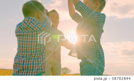 Winning team splash of little boys hands at sunset 38702844