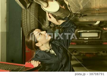 Female master is repairing car on her workplace Female master is repairing car on her workplace 38708791