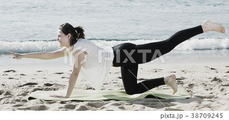 Girl in white T-shirt is practicing yoga 38709245