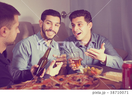 Three men talking and laughing at home 38710071