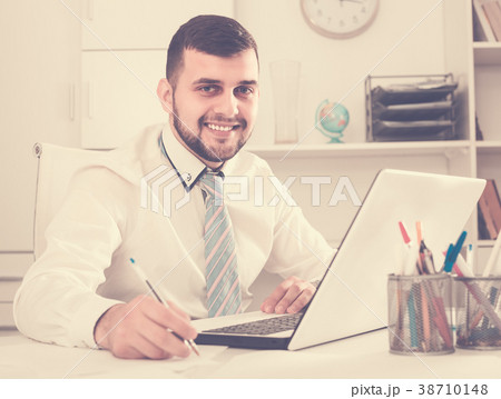 Male employee is having productive day at work 38710148