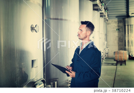 Portrait of man wearing coat taking off data from equipment Portrait of man wearing coat taking off data from equipment 38710224
