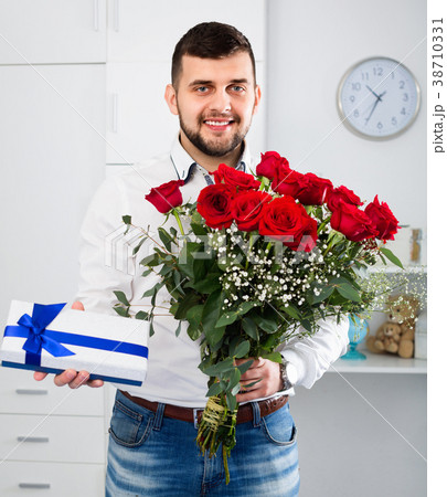 Man ready to present flowers and gift at holiday Man ready to present flowers and gift at holiday 38710331