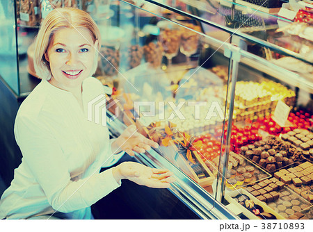 Senior customer choosing chocolates. Senior customer choosing chocolates. 38710893