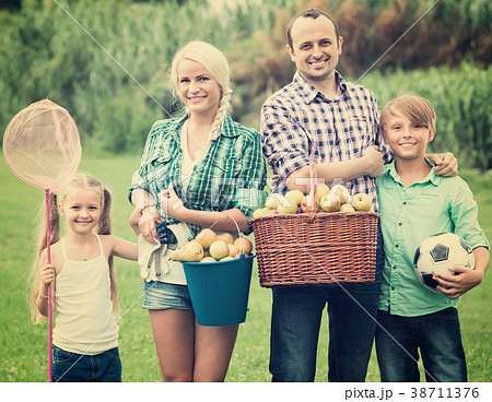 Family of four resting at countryside. Family of four resting at countryside. 38711376