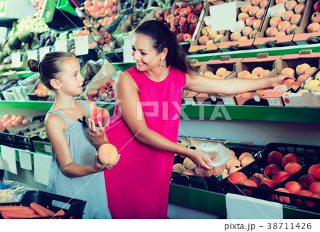 Woman with daughter picking peaches 38711426