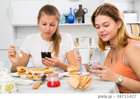 friends drinking tea with mobile phone 38711427