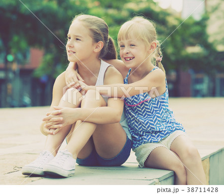 Two small happy sisters outdoors 38711428
