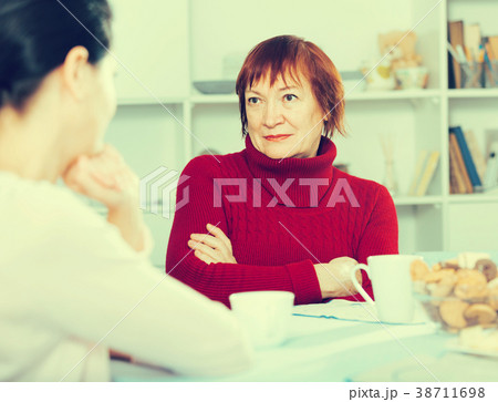 Portrait of sad mature woman talking with daughter 38711698