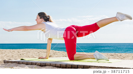 Woman doing yoga sitting 38711715