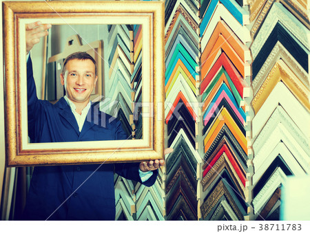 portrait of man seller working with picture frames in atelier portrait of man seller working with picture frames in atelier 38711783