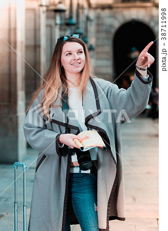 Woman having pamphlet and looking for her route Woman having pamphlet and looking for her route 38711998