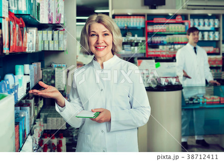 Portrait of two pharmacists working in modern farmacy Portrait of two pharmacists working in modern farmacy 38712411