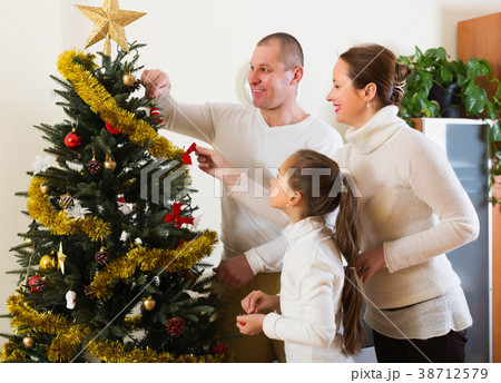 Happy family preparing for Christmas Happy family preparing for Christmas 38712579