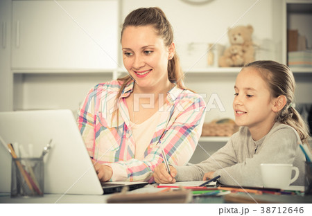 Smiling schoolgirl and young mother Smiling schoolgirl and young mother 38712646