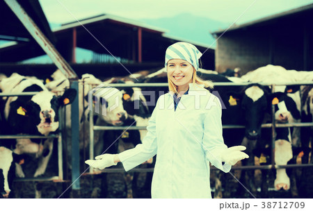 Young woman in white gown at livestock farm 38712709