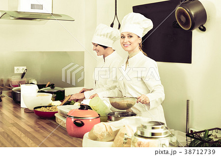 Female chefs preparing food on restaurant kitchen Female chefs preparing food on restaurant kitchen 38712739