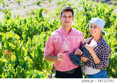 Two farmers posing with wine and grape Two farmers posing with wine and grape 38712761