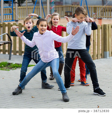 Children showing different figures during game in playground Children showing different figures during game in playground 38712830