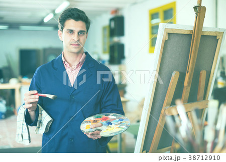 Man near easel painting on canvas Man near easel painting on canvas 38712910