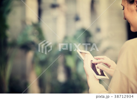 Ordinary woman looking for the map in the phone 38712934