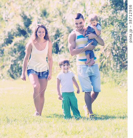 Family of four in sunny park 38712936