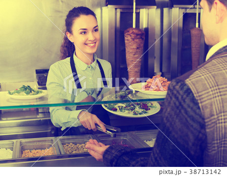 Girl and satisfied customer buying kebab 38713142