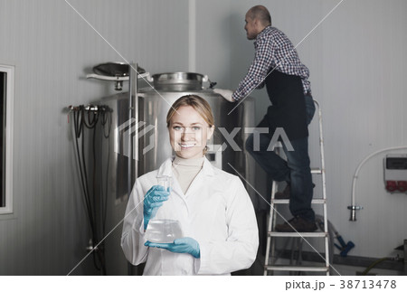Two brewery workers on beer factory. Two brewery workers on beer factory. 38713478