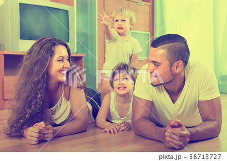 Happy family of four at home 38713727