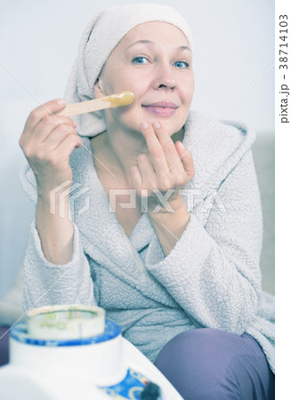 Woman doing body hair removal Woman doing body hair removal 38714103