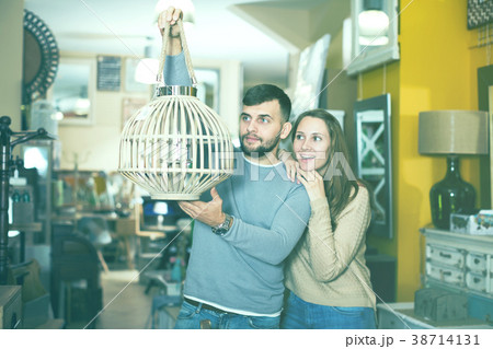 Happy couple with vintage suspended lamp 38714131