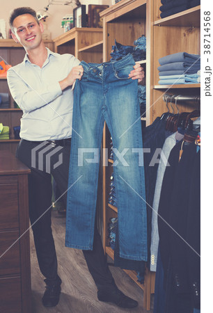 Adutl man is choosing on new jeans Adutl man is choosing on new jeans 38714568