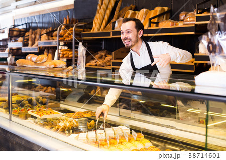 Man offers a selection of baking Man offers a selection of baking 38714601