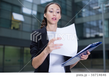 Businesswoman is examining documents 38714646