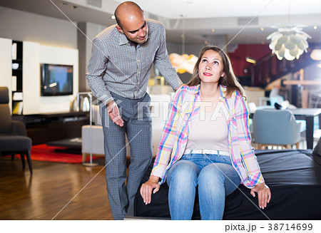 couple testing new bed in modern home furnishings store couple testing new bed in modern home furnishings store 38714699