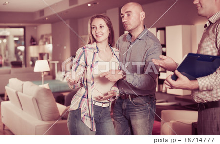 Customers are consulting with seller to choose new sofa Customers are consulting with seller to choose new sofa 38714777