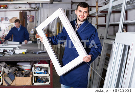 Workmen inspecting PVC manufacturing output in workshop Workmen inspecting PVC manufacturing output in workshop 38715051