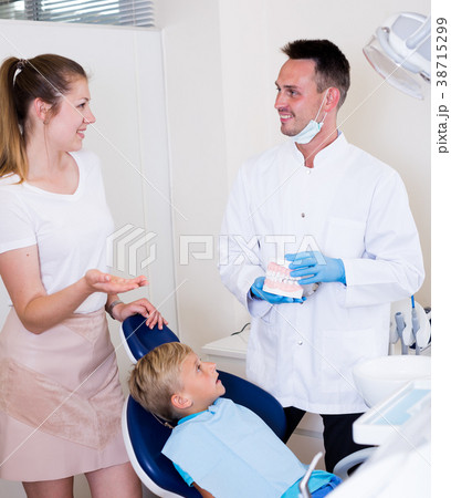 Adult woman is talking with dentist about her child`s health Adult woman is talking with dentist about her child`s health 38715299