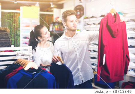 Loving couple deciding on new sportswear Loving couple deciding on new sportswear 38715349
