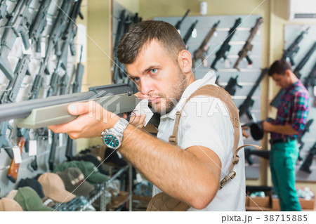 Men choosing air weapon 38715885