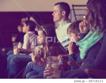 People eating popcorn in cinema People eating popcorn in cinema 38716211